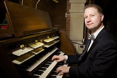 Organist Johann Vexo seated at the Kilgen Pipe Organ at Our Lady of Refuge in Brooklyn