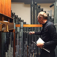 James Konzelman, organ builder, tuning organ.